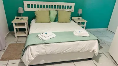 a bedroom with a bed with towels on it at UrbanStay in Pretoria