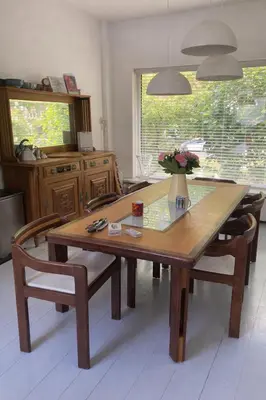 a wooden table in a kitchen with chairs and a table at UrbanStay in Pretoria