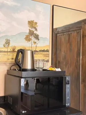 a coffee pot sitting on top of a television at Dunamis Lodge in Giyani