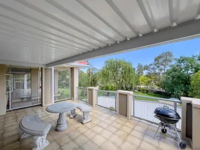 a large screened porch with a table and a grill at Donovan Heights 35 in Midrand