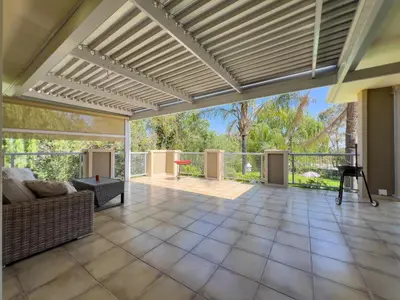 an open living room with a couch and a patio at Donovan Heights 35 in Midrand
