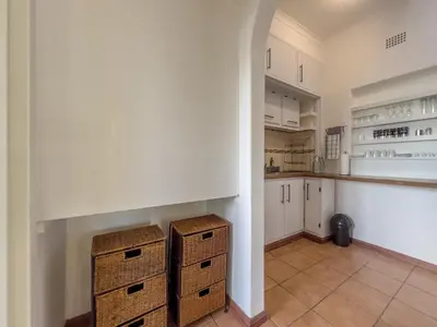 a kitchen with white cabinets and a counter at Donovan Heights 35 in Midrand