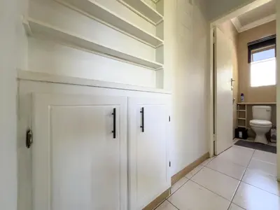 a bathroom with white cabinets and a toilet at Donovan Heights 35 in Midrand