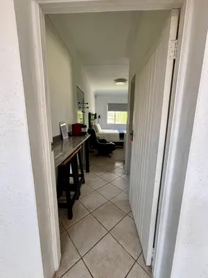 a hallway with a desk and a table in a room at Donovan Heights 35 in Midrand