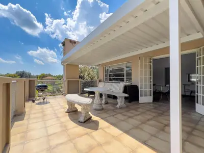 an outdoor patio with a table and a bench at Donovan Heights 35 in Midrand