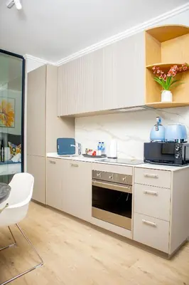 a kitchen with white cabinets and a stove top oven at Ellipse Waterfall Premium Apartments - Blue in Johannesburg