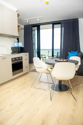 a kitchen and dining room with a table and chairs at Ellipse Waterfall Premium Apartments - Blue in Johannesburg
