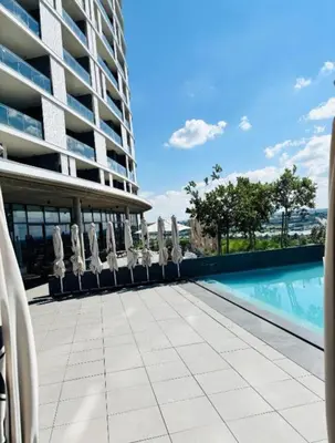 a swimming pool in front of a building at Ellipse Waterfall Premium Apartments - Blue in Johannesburg
