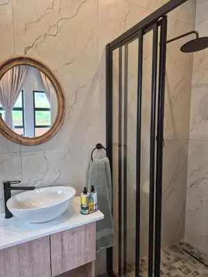 a bathroom with a sink and a mirror at Highland Gate 948 in Dullstroom