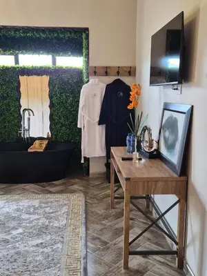 a room with a table and a bathtub and a table with a table sidx at Highland Gate 948 in Dullstroom