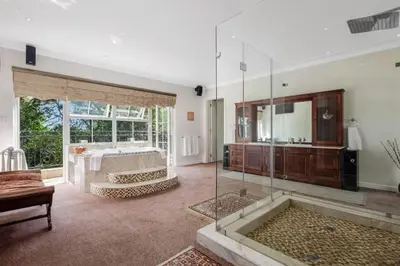 a large bathroom with a shower and a tub at Manor On Main in Midrand