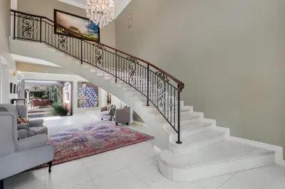 a staircase in a home with a living room at Manor On Main in Midrand