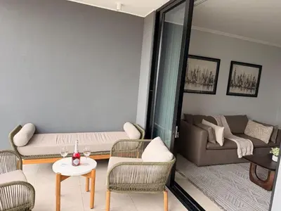 a living room with a couch and a table and chairs at Riviera Château de Rêve - Phoenix's Gîte at Ellipse Waterfall, Midrand in Midrand