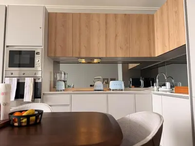 a kitchen with a table and chairs and a counter top at Riviera Château de Rêve - Phoenix's Gîte at Ellipse Waterfall, Midrand in Midrand