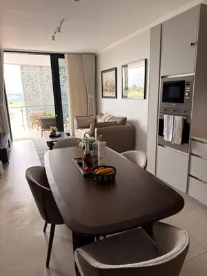 a kitchen and living room with a table and chairs at Riviera Château de Rêve - Phoenix's Gîte at Ellipse Waterfall, Midrand in Midrand
