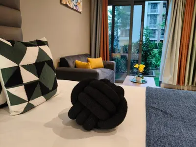 a black glove sitting on top of a bed at Comfort at 35 Menlyn Maine Residences in Pretoria