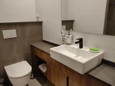 a bathroom with a white sink and a toilet at Comfort at 35 Menlyn Maine Residences in Pretoria