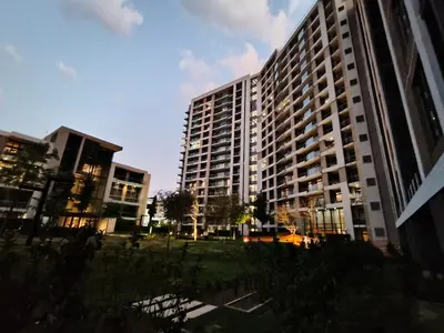 a tall building with a grassy field in front of it at Comfort at 35 Menlyn Maine Residences in Pretoria