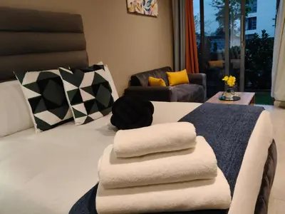 a hotel room with a bed with towels on it at Comfort at 35 Menlyn Maine Residences in Pretoria