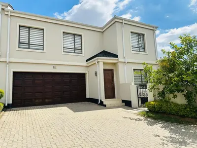 a large white house with a garage at Casa Maison - Stylish 3 Bedroom in Summerset, Midrand in Midrand