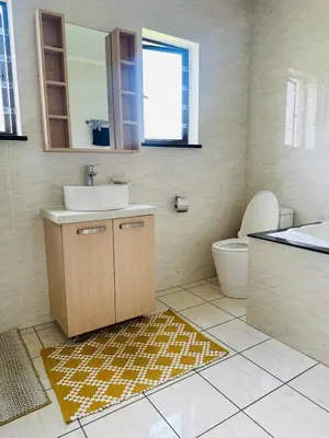 a bathroom with a sink and a toilet at Casa Maison - Stylish 3 Bedroom in Summerset, Midrand in Midrand