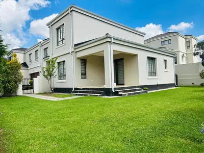 a large white house with a green yard at Casa Maison - Stylish 3 Bedroom in Summerset, Midrand in Midrand