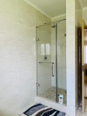 a shower with a glass door in a bathroom at Casa Maison - Stylish 3 Bedroom in Summerset, Midrand in Midrand