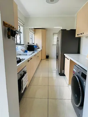 a kitchen with a washer and dryer in it at Casa Maison - Stylish 3 Bedroom in Summerset, Midrand in Midrand