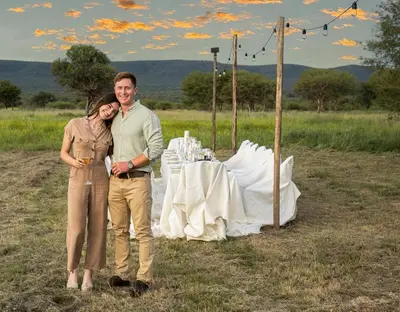 a man and a woman standing in front of a table at Babirwa in Rooiberg