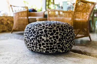 a black and white ottoman sitting on the floor at Babirwa in Rooiberg