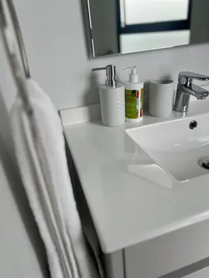 a bathroom counter with a sink and a mirror at Havana at Ellipse Waterfall in Midrand