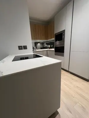 a kitchen with a white counter and a refrigerator at Havana at Ellipse Waterfall in Midrand