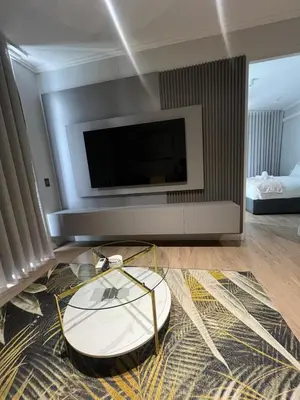 a living room with a tv and a coffee table at Havana at Ellipse Waterfall in Midrand