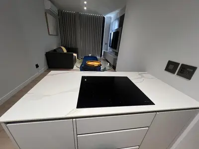 a kitchen with a white counter top in a room at Havana at Ellipse Waterfall in Midrand
