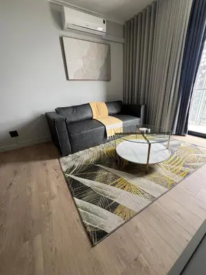 a living room with a couch and a glass table at Havana at Ellipse Waterfall in Midrand