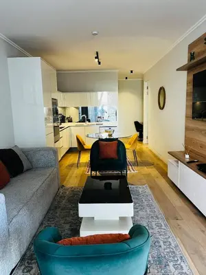 a living room with a couch and a table at Ellipse Waterfall 2BR with Pool, Restaurant & Gym in Midrand