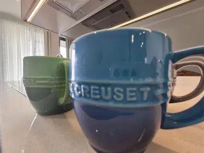 two coffee cups sitting on top of a counter at One Palm at Ellipse Waterfall in Midrand