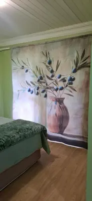 a bedroom with a painting of a vase on the wall at Olive Studio in Pretoria