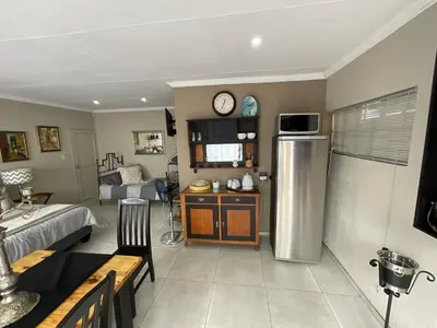 a room with a kitchen and a living room at ColtsRest in White River
