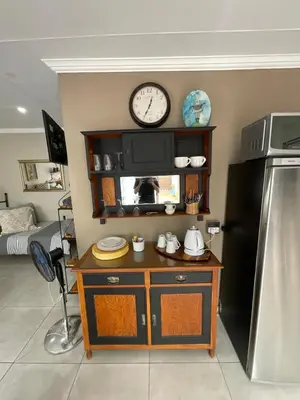 a kitchen with a counter with a clock on the wall at ColtsRest in White River