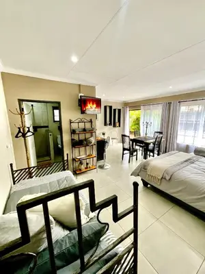 a bedroom with two beds and a dining room with a table at ColtsRest in White River