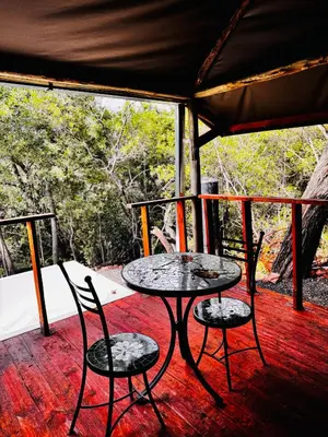 a table and two chairs on a porch at Thaba View Luxury Tent in Hartbeespoort