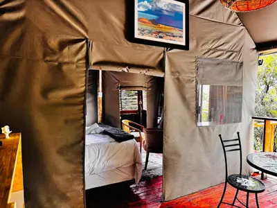a room with a bed in a tent at Thaba View Luxury Tent in Hartbeespoort