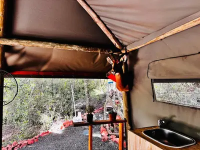 a camper with a chicken hanging from the side of it at Thaba View Luxury Tent in Hartbeespoort