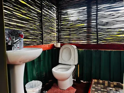 a bathroom with a toilet and a sink at Thaba View Luxury Tent in Hartbeespoort