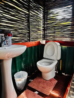 a bathroom with a toilet and a sink at Thaba View Luxury Tent in Hartbeespoort
