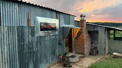a building with a sign on the side of it at Rocks & Roses SinknBlink in Lochiel