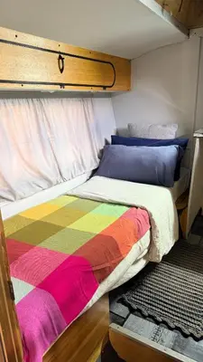 a bed with a colorful blanket on it in a room at Rocks & Roses SinknBlink in Lochiel