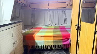 a colorful bed in the back of an rv at Rocks & Roses SinknBlink in Lochiel
