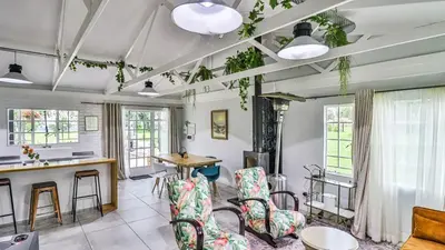 a living room with chairs and a table at Cottage Daisy in Doornrandjies